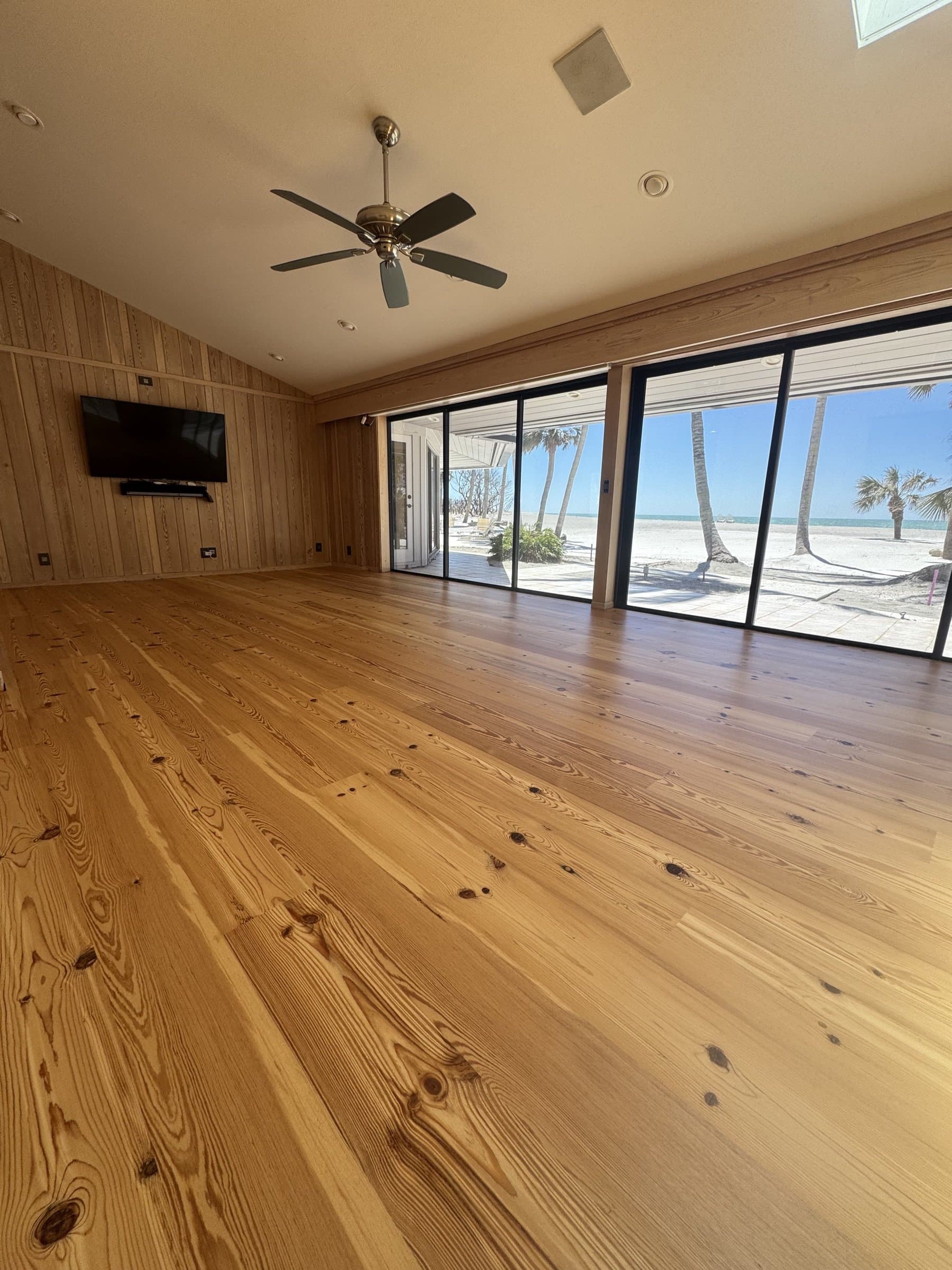 Hardwood flooring in a beachfront living room with ocean-view windows